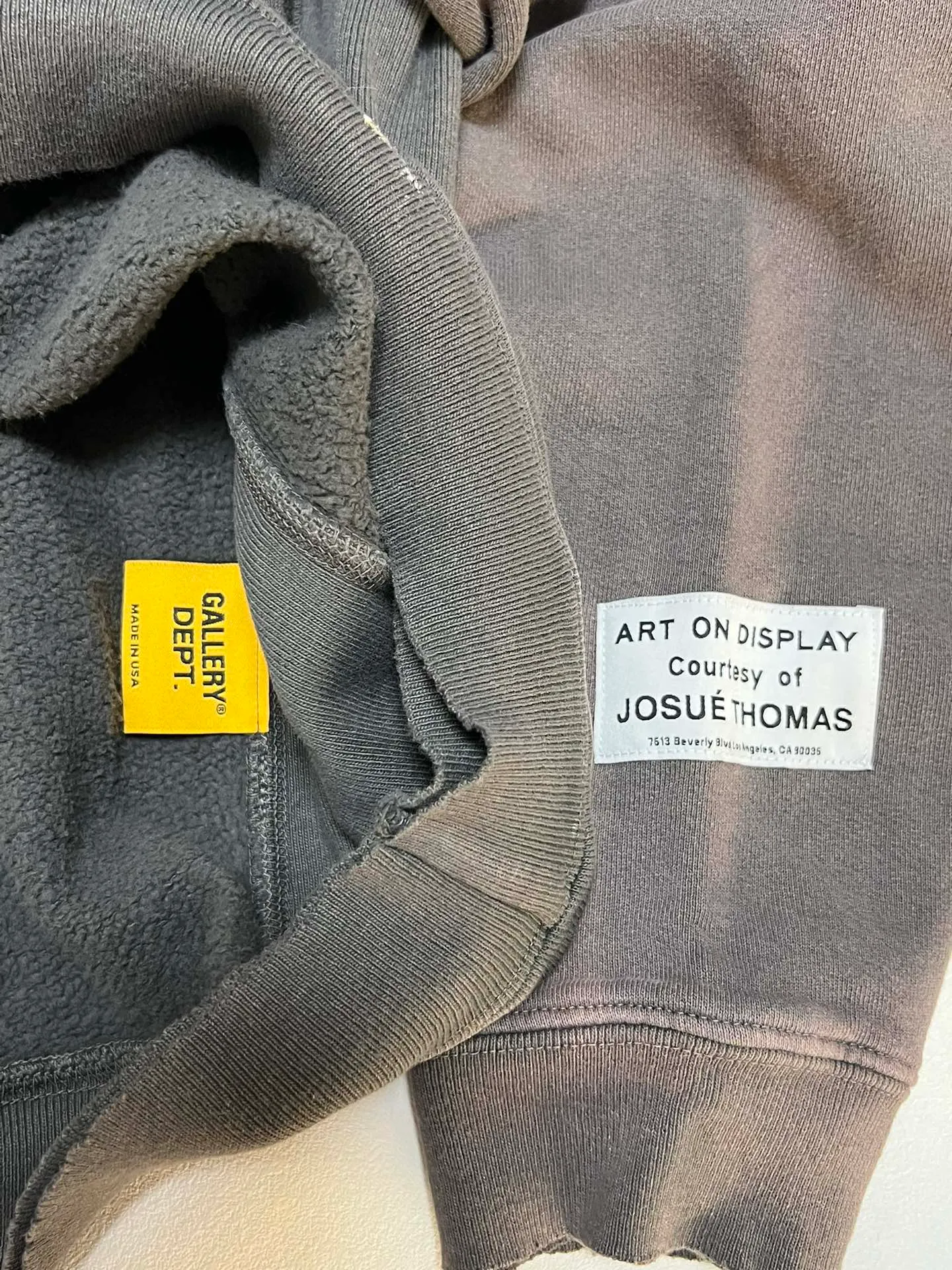 GALLERY DEPT. 90'S RECYCLE HOODIE WASHED BLACK 90'S washed hoodie with distressed eco-friendly slogans. Washed black S-XL. Ready-made garments are washed and dyed again. Multiple spots throughout the body are spray-faded. The ribs are cut and worn.